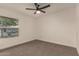 Bedroom featuring neutral carpeting, a window providing natural light and a ceiling fan at 908 W Mohawk Ln, Phoenix, AZ 85027