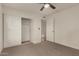 Bedroom featuring carpet flooring, closet, ceiling fan, and a view of the adjacent room at 908 W Mohawk Ln, Phoenix, AZ 85027
