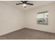 Cozy bedroom with a ceiling fan and a window offering natural light and neighborhood views at 908 W Mohawk Ln, Phoenix, AZ 85027