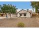 Exterior view of a single-story home with a two-car garage and gravel landscaping at 908 W Mohawk Ln, Phoenix, AZ 85027