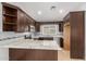 Kitchen featuring stainless steel appliances, granite countertops, and dark wood cabinetry at 908 W Mohawk Ln, Phoenix, AZ 85027