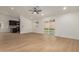 Bright, open-concept living area with modern lighting, laminate floors and access to kitchen and backyard at 908 W Mohawk Ln, Phoenix, AZ 85027