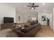 Bright living room featuring a brown sectional sofa, wood floors, and an open concept dining area at 908 W Mohawk Ln, Phoenix, AZ 85027