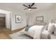 Bright main bedroom with light-colored walls, a white bedspread, and an ensuite bathroom at 908 W Mohawk Ln, Phoenix, AZ 85027