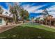 Large backyard with artificial turf, mature trees, and a fenced in pool at 9265 E Kalil Dr, Scottsdale, AZ 85260