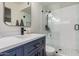 Modern bathroom featuring a glass shower, navy vanity, white countertop, and stylish fixtures at 9265 E Kalil Dr, Scottsdale, AZ 85260