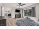 Primary bedroom featuring a ceiling fan, a large window, and a television at 9265 E Kalil Dr, Scottsdale, AZ 85260
