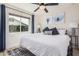 Cozy bedroom boasts a ceiling fan, a large window, and stylish wall art at 9265 E Kalil Dr, Scottsdale, AZ 85260