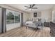 Relaxing bedroom featuring a large window, a ceiling fan, and comfortable furniture at 9265 E Kalil Dr, Scottsdale, AZ 85260