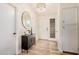 Stylish entryway with wood floors, modern light fixture, and decorative mirror at 9265 E Kalil Dr, Scottsdale, AZ 85260