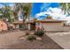Inviting single-story home featuring low maintenance desert landscaping and a two-car garage at 9265 E Kalil Dr, Scottsdale, AZ 85260