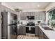 Contemporary kitchen boasting stainless steel appliances, gray cabinetry, and stylish countertops at 9265 E Kalil Dr, Scottsdale, AZ 85260