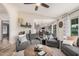 Cozy living room showcasing stylish gray couches and an open layout to the dining area at 9265 E Kalil Dr, Scottsdale, AZ 85260