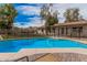 Inviting backyard pool with blue water, surrounded by a safety fence and views of the home's exterior at 9265 E Kalil Dr, Scottsdale, AZ 85260