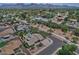 Expansive aerial view showcasing the neighborhood, backing up to mountains, with tree-lined streets at 9476 E Laurel Ln, Scottsdale, AZ 85260
