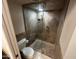 Bathroom with a glass enclosed shower and stone tile throughout at 9476 E Laurel Ln, Scottsdale, AZ 85260