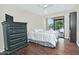 Bedroom with dark wood floors, dresser, and natural light at 9476 E Laurel Ln, Scottsdale, AZ 85260