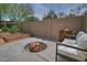 Backyard features a firepit, garden, and sitting area with a stacked firewood at 9476 E Laurel Ln, Scottsdale, AZ 85260