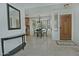 Bright entryway featuring tile flooring, entry table, chandelier, and a view of the dining area at 9476 E Laurel Ln, Scottsdale, AZ 85260