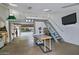 This garage has skylights and a modern interior, and features stairs to a large upper mezzanine for storage or hobbies at 9476 E Laurel Ln, Scottsdale, AZ 85260
