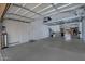 Large garage space with high ceilings, overhead storage, and ample room for parking at 9476 E Laurel Ln, Scottsdale, AZ 85260