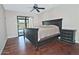 Serene main bedroom with wood floors, ceiling fan, and sliding glass doors to the pool at 9476 E Laurel Ln, Scottsdale, AZ 85260
