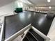 The spacious upper mezzanine is accessed by metal stairs, and features a heavy-duty rubber floor and large windows at 9476 E Laurel Ln, Scottsdale, AZ 85260