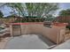 Outdoor kitchen with built-in grill and stainless steel refrigerator at 9476 E Laurel Ln, Scottsdale, AZ 85260