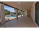 Long covered patio overlooking the backyard pool and landscaping at 9476 E Laurel Ln, Scottsdale, AZ 85260