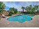 Beautiful in-ground swimming pool and deck area surrounded by lush greenery at 9476 E Laurel Ln, Scottsdale, AZ 85260
