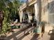 Covered patio area with outdoor lounge chairs, dining table and a nearby pool at 10175 E Cochise Dr, Scottsdale, AZ 85258