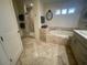 Luxurious bathroom with a soaking tub, walk-in shower, and elegant tile work at 10175 E Cochise Dr, Scottsdale, AZ 85258