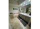 Bathroom featuring double sinks, granite countertops, and a soaking tub for a luxurious bathing experience at 10175 E Cochise Dr, Scottsdale, AZ 85258