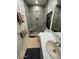 Bathroom featuring a glass enclosed shower, tiled walls, and a bright vanity area at 10175 E Cochise Dr, Scottsdale, AZ 85258