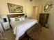 Comfortable bedroom with a large bed, lamps, and a world map decoration at 10175 E Cochise Dr, Scottsdale, AZ 85258