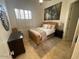 Comfortable bedroom featuring a wicker bed frame, natural light, and soft textures at 10175 E Cochise Dr, Scottsdale, AZ 85258