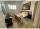 Cozy bedroom featuring a wicker bed frame, natural light, and soft textures at 10175 E Cochise Dr, Scottsdale, AZ 85258