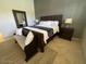 Comfortable bedroom with a wooden bed, matching furniture, and neutral color palette at 10175 E Cochise Dr, Scottsdale, AZ 85258