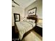 An inviting bedroom featuring a carved wood bedframe, stylish side tables and elegant tile flooring at 10175 E Cochise Dr, Scottsdale, AZ 85258