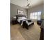 Bedroom featuring a ceiling fan, a bed with decorative pillows, and a cozy seating area by the window at 10175 E Cochise Dr, Scottsdale, AZ 85258