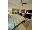 Comfortable bedroom features a plush bed, ceiling fan, and natural lighting from window at 10175 E Cochise Dr, Scottsdale, AZ 85258