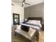 Bedroom featuring a king-sized bed with wood frame and a dark accent wall at 10175 E Cochise Dr, Scottsdale, AZ 85258