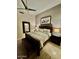 Relaxing bedroom with a ceiling fan, elegant bedding, and stylish decorations creates a calm atmosphere at 10175 E Cochise Dr, Scottsdale, AZ 85258