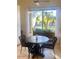Cozy breakfast nook with seating for four and views of lush landscaping at 10175 E Cochise Dr, Scottsdale, AZ 85258