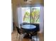 Cozy dining area with a round table and views of lush greenery at 10175 E Cochise Dr, Scottsdale, AZ 85258