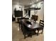 Dining room with a large wooden table and chairs, perfect for hosting gatherings and enjoying meals at 10175 E Cochise Dr, Scottsdale, AZ 85258