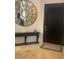 Stylish entryway featuring an accent wall, a large mirror and a dark wood door at 10175 E Cochise Dr, Scottsdale, AZ 85258
