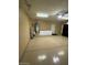 Large two-car garage with an epoxy floor, utility sink, white cabinets, and room for vehicles at 10175 E Cochise Dr, Scottsdale, AZ 85258