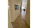 Hallway with neutral tile flooring and wall art leading to the living area, offering a bright and inviting path at 10175 E Cochise Dr, Scottsdale, AZ 85258