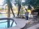 Backyard patio featuring a private hot tub with waterfront views and patio chairs at 10175 E Cochise Dr, Scottsdale, AZ 85258